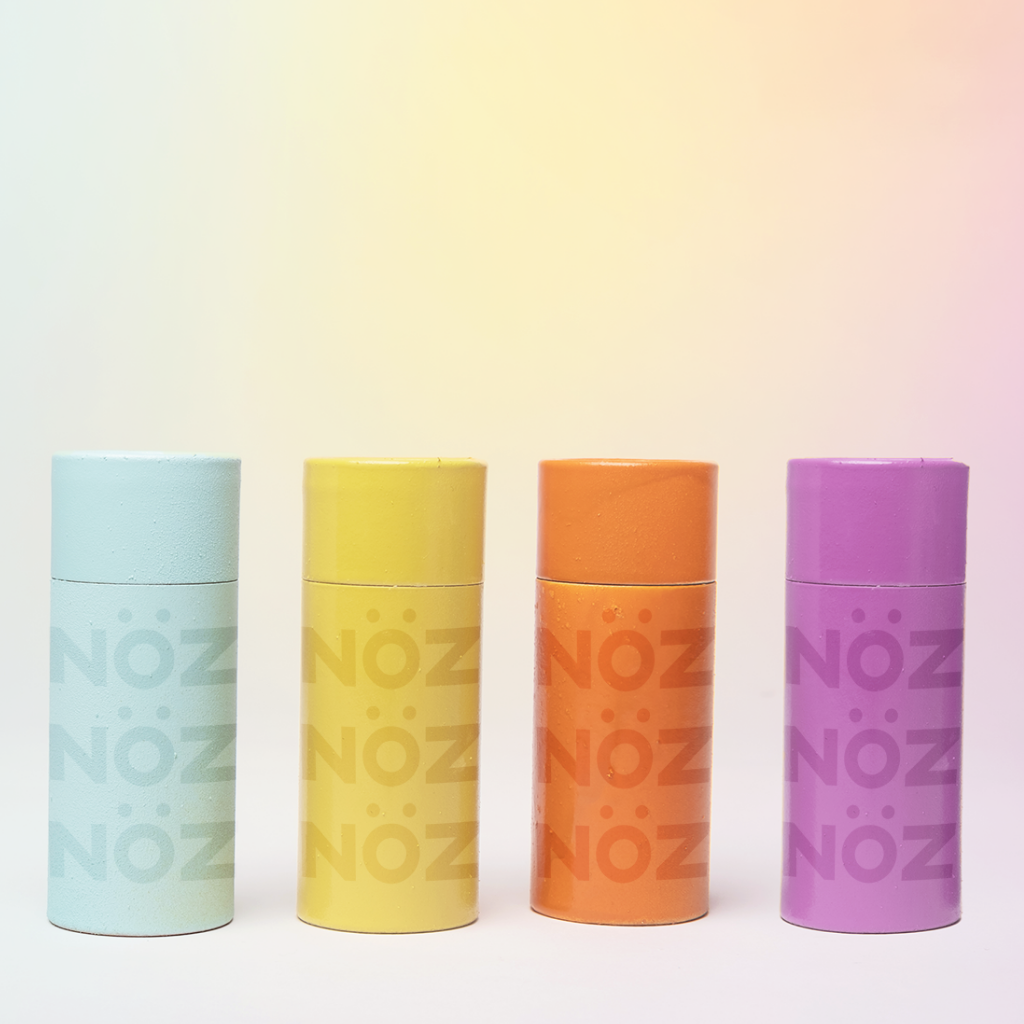 Noz dermatologist-recommended biodegradable colorful sunscreen, Shown in blue, yellow. orange, and purple.